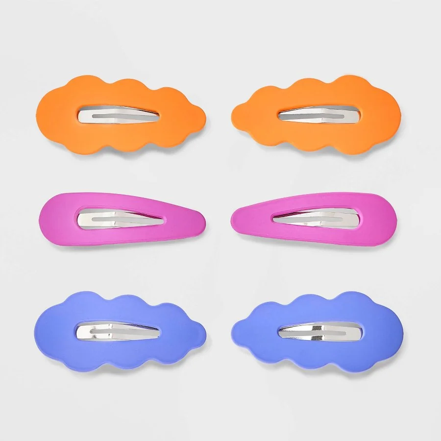 Six large soft-touch covered snap hair clips in soft pastel shades on a white background