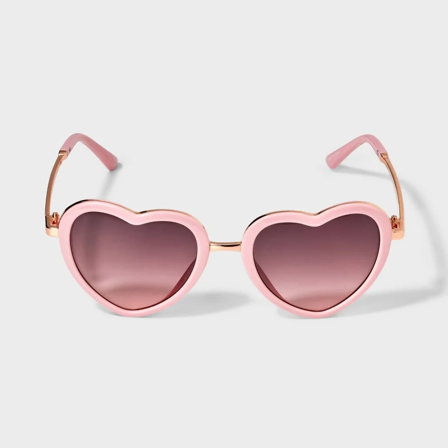 Light pink girls heart aviator sunglasses with tinted lenses on a white background