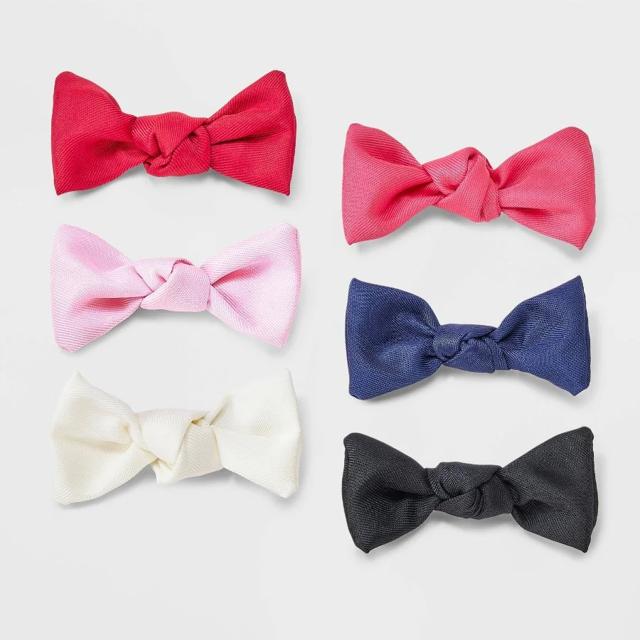 Six grosgrain ribbon bow hair clips in assorted colors on a white background